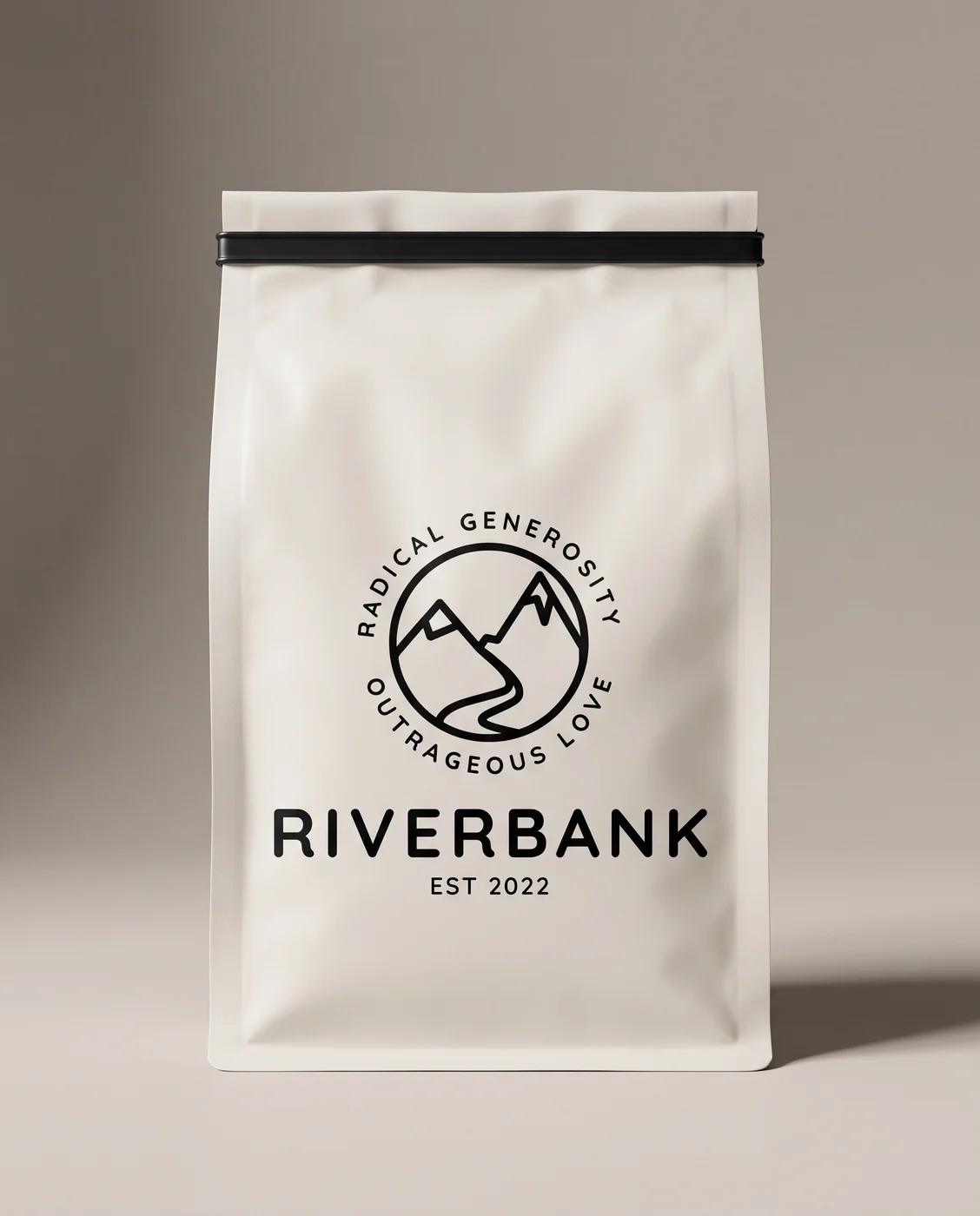 A bone-coloured Riverbank Coffee Roasters bag with the black Riverbank badge and wordmark printed on the front